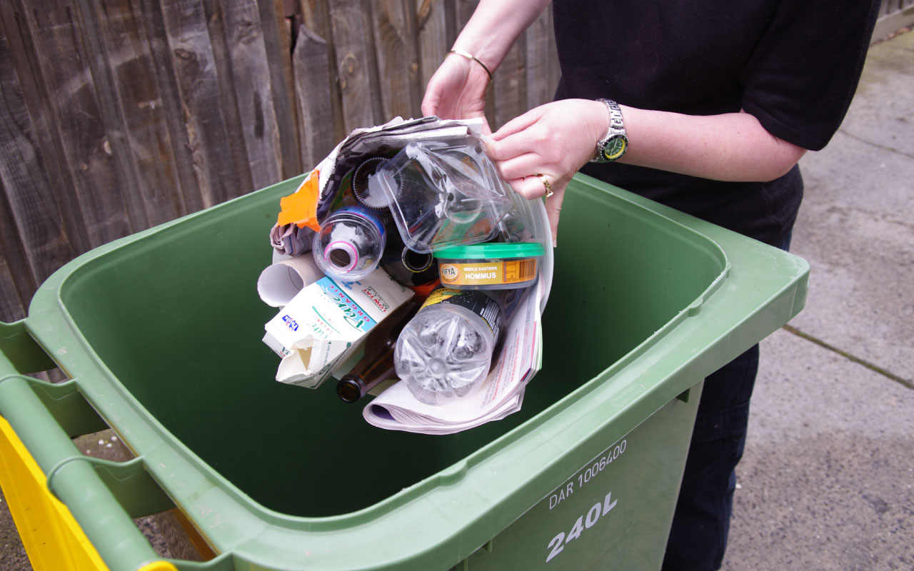 Woman recycling in bin